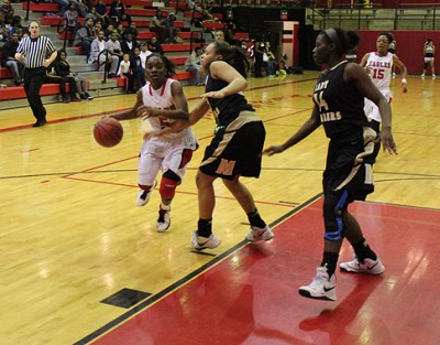 Dionna Collins drives past Kara Partridge.