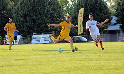 Oklahoma City FC forward Tommy Hubbard (center) scores a goal in the 27th minute in a game on July 20th against the Houston Dutch Lions at Oklahoma City University's Stars Field. OKC FC forward Adam Black (left) and Houston defender Walter Kromholz look on. �
