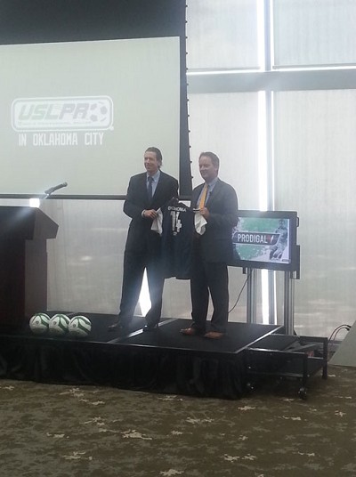USL President Tim Holt (left) and Prodigal's John ALllgood hold a symbolic jersey at the July 2 press conference to announce the arrival of professional soccer in Oklahoma City.