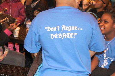 Debators represent their school based on the colors of their shirts which are adorned with a tie graphic on front and the debate logo on the back. (Photo by Joel Dean)